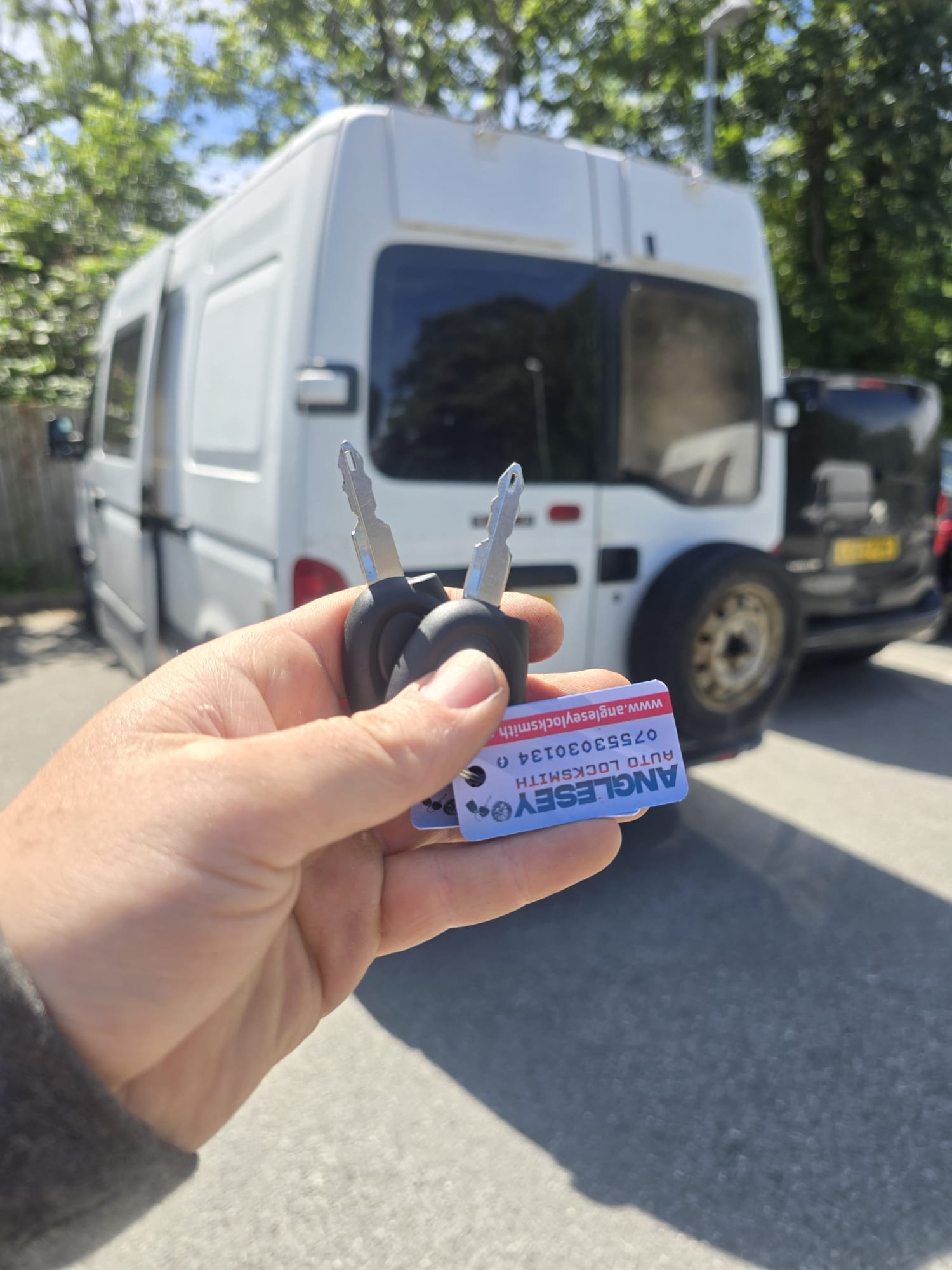 Auto locksmith completing a car key replacement in Anglesey